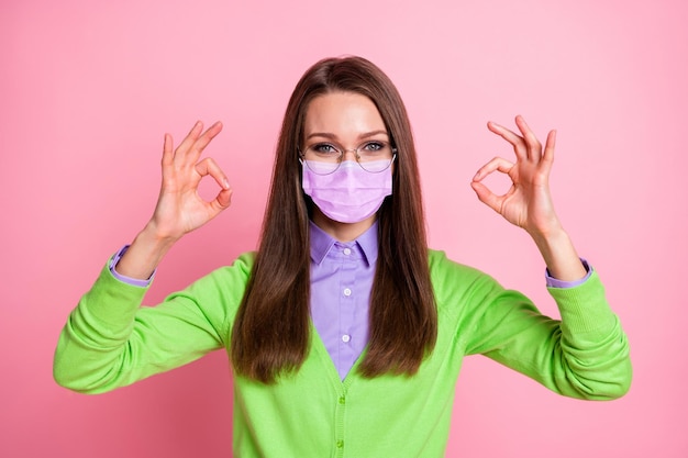 Portrait of positive cute girl show okay sign wear mask spectacles isolated over pastel color background