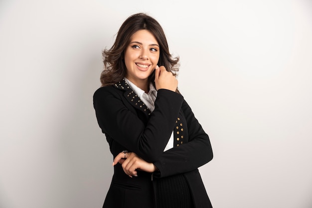 Portrait of positive woman posing on white