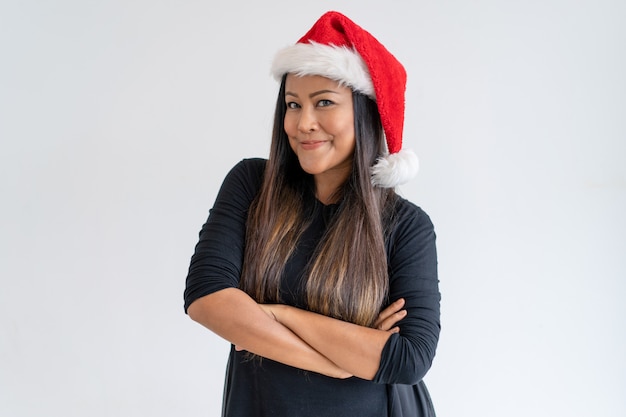 Portrait of positive young woman in Christmas hat