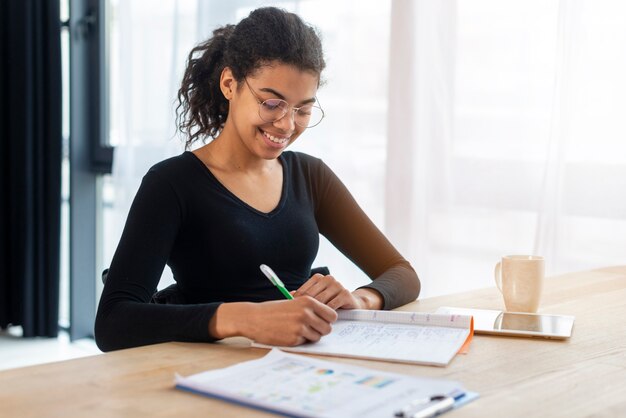 Portrait of positive young woman working at the office