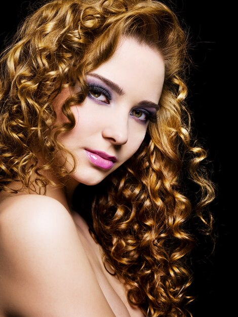 Portrait of a pretty adult girl with  long  hairs - On a black background