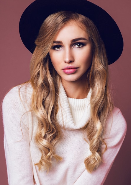 Portrait of pretty  blonde woman in hat posing