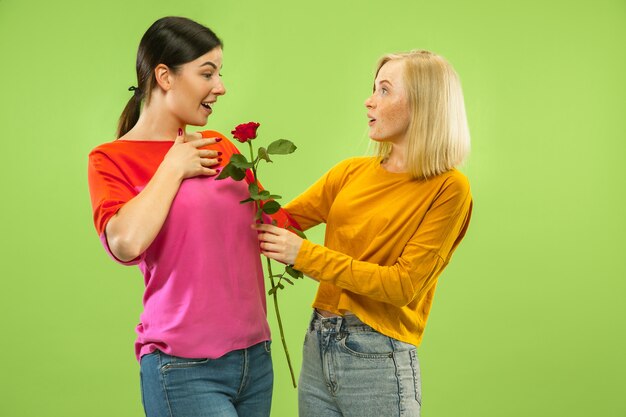 Portrait of pretty charming girls in casual outfits isolated. Two female models as a girlfriends or lesbians. Concept of LGBT, equality, human emotions, love, relation.