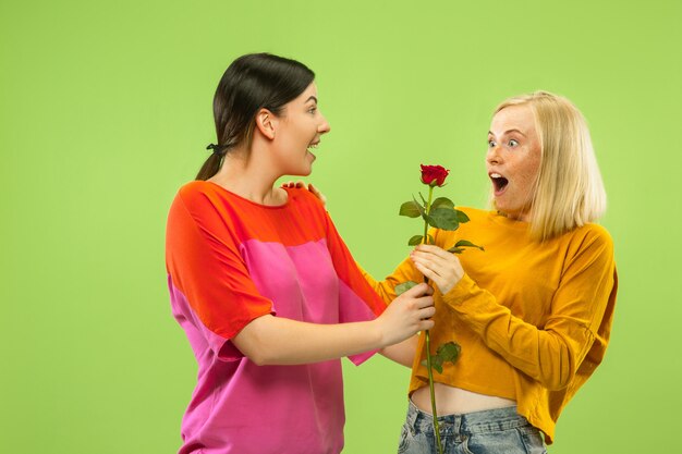 Portrait of pretty charming girls in casual outfits isolated. Two female models as a girlfriends or lesbians. Concept of LGBT, equality, human emotions, love, relation.