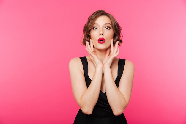 Portrait of a pretty girl dressed in black dress shouting