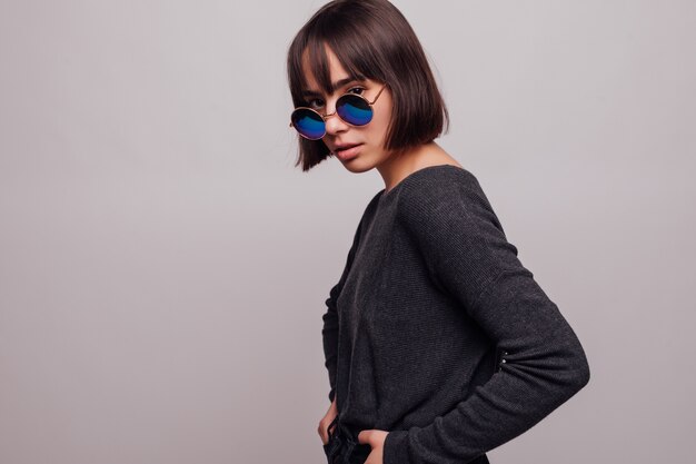 Portrait of pretty girl teenager in sunglasses isolated.