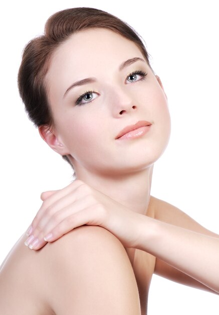 portrait of a pretty, glamorous, bare-shouldered teenage girl with short, reddish hair.