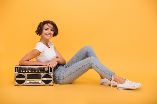 Portrait of a pretty lovely woman sitting with record player