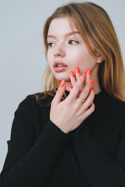 Portrait of a pretty smiling woman posing isolated