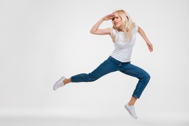 Portrait of a pretty woman jumping and looking