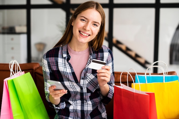 Portrait of pretty woman with phone and card