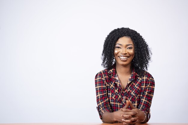 Portrait of a pretty young black female sitting at a desk