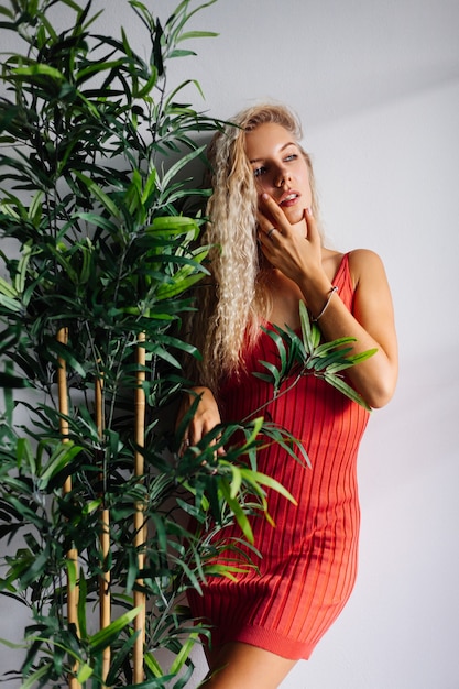 Free photo portrait of pretty young caucasian woman with light natural make up in red mini dress