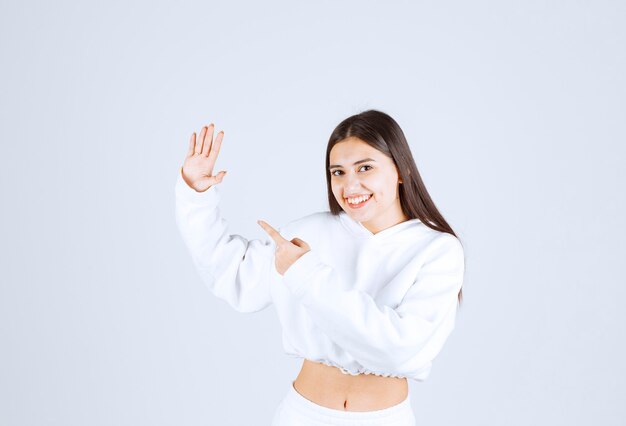 Portrait of pretty young girl model posing and looking forward.