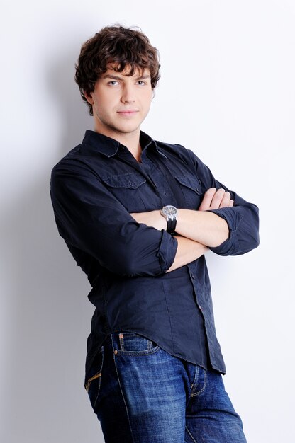 Portrait of a pretty young guy posing in the studio