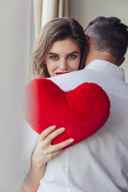 Portrait of a pretty young woman holding her boyfriend