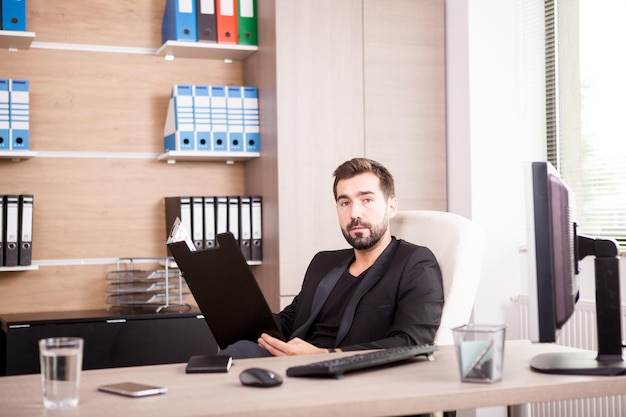 Portrait of professional Businessman working in his office. Businessperson in professional environment