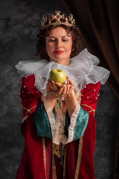 Portrait of queen with crown and apple fruit