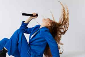 Free photo portrait of redhaired singing woman with micorphone