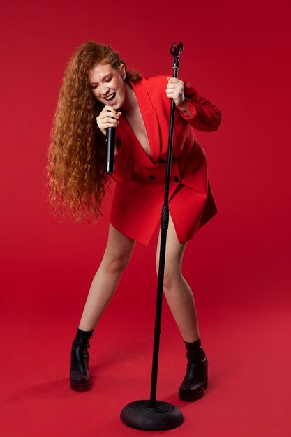 portrait of redhaired singing woman with micorphone
