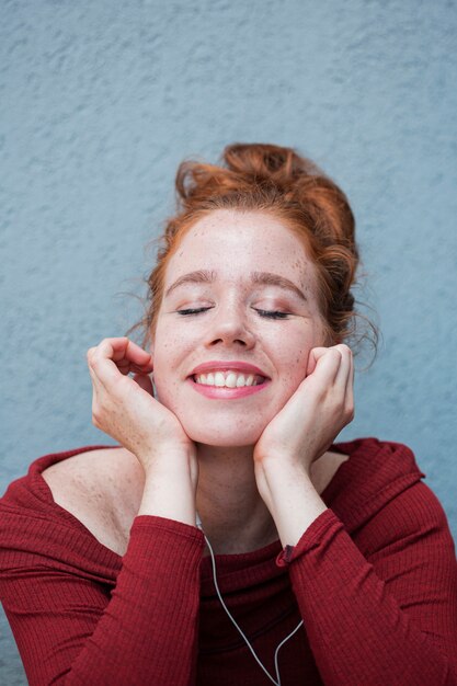 Portrait of redhead woman listening to music