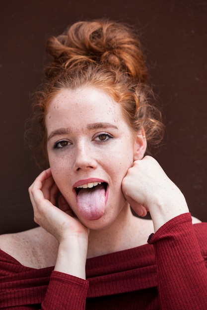 Portrait of redhead woman making faces