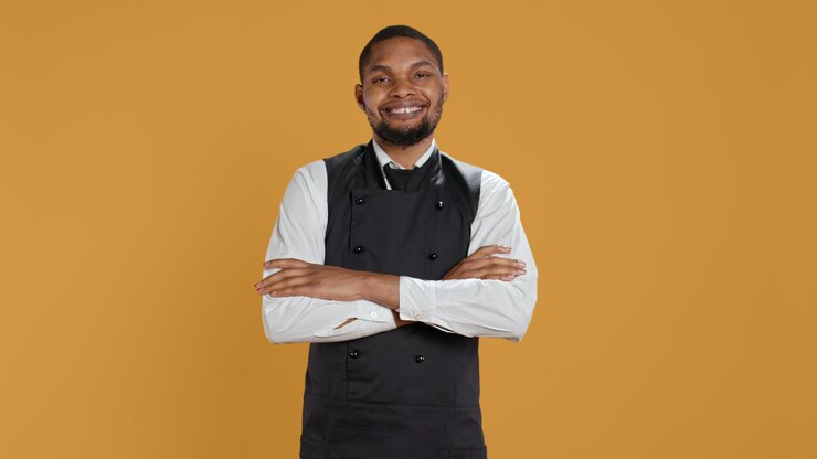 Free Photo portrait of restaurant waiter wearing professional uniform and apron