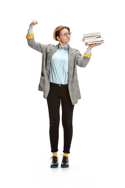 Portrait of a sad female student holding books isolated on white wall