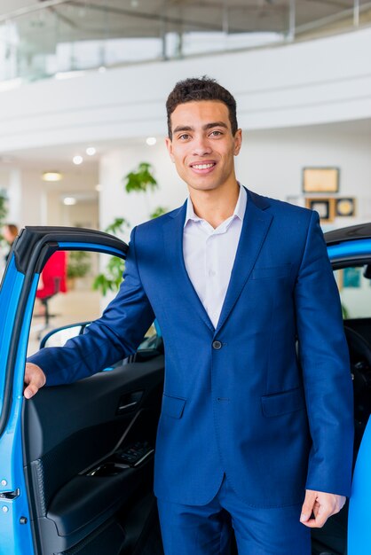 Portrait of salesman in car dealership