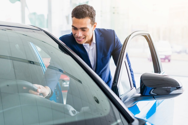 Portrait of salesman in car dealership