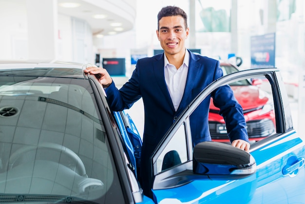 Portrait of salesman in car dealership