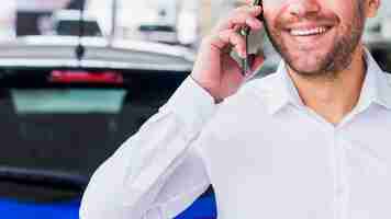 Free photo portrait of salesman in car dealership