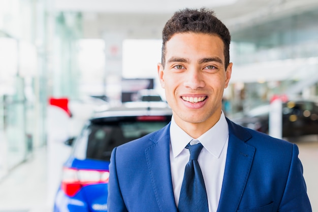 Portrait of salesman in car dealership