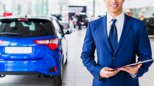 Portrait of salesman in car dealership