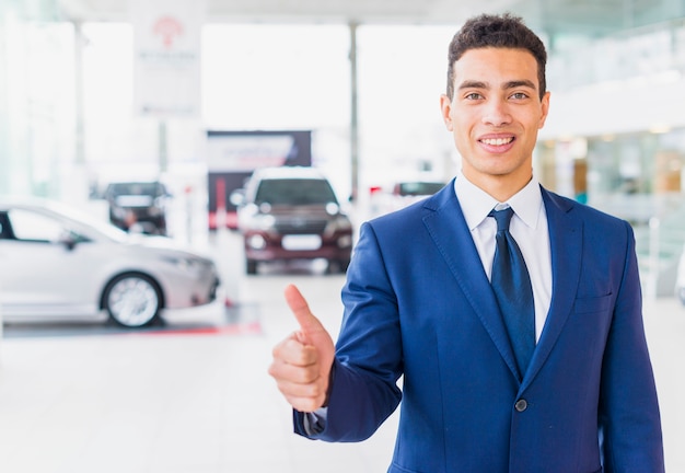 Free photo portrait of salesman in car dealership