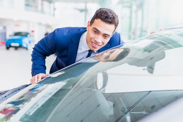 portrait of salesman in car dealership