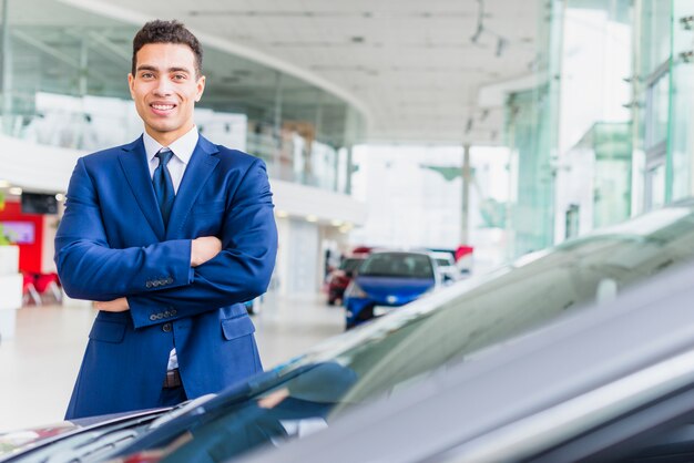 Portrait of salesman in car dealership