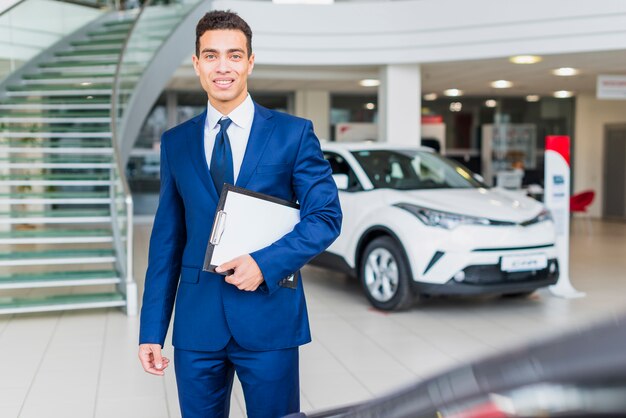 Portrait of salesman in car dealership