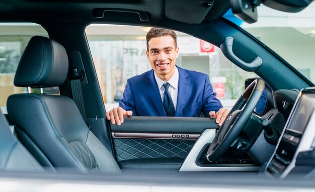 Portrait of salesman in car dealership