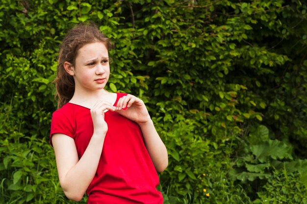 Portrait of scared girl standing in park