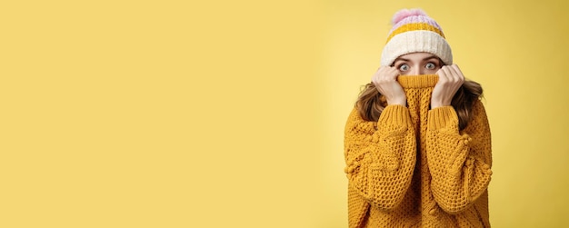 Free photo portrait scared insecure timid cute girl hiding face pull sweater nose widen eyes afraid stunned sta