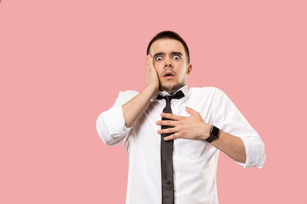 Portrait of the scared man. Business man standing isolated on trendy pink studio background. male half-length portrait.