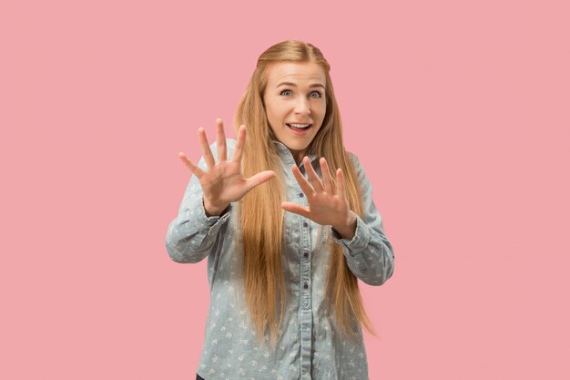 Portrait of the scared woman on pink