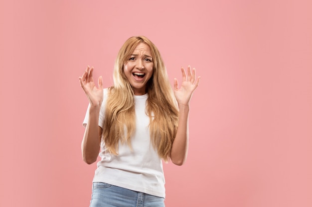 Portrait of the scared woman on pink