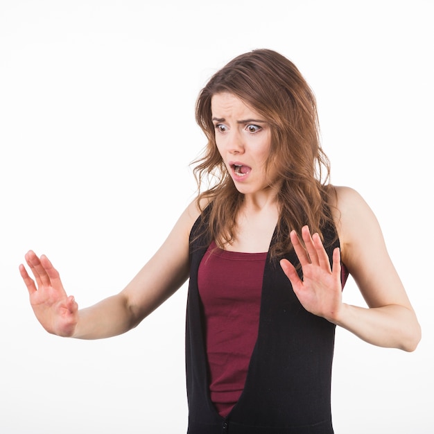 Free photo portrait of scared woman raising hands up in defense