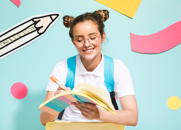 Portrait of schoolgirl on a memphis background