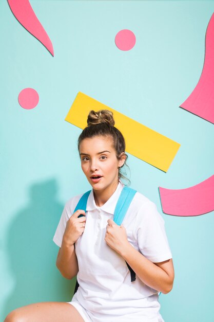 Portrait of schoolgirl on a memphis background