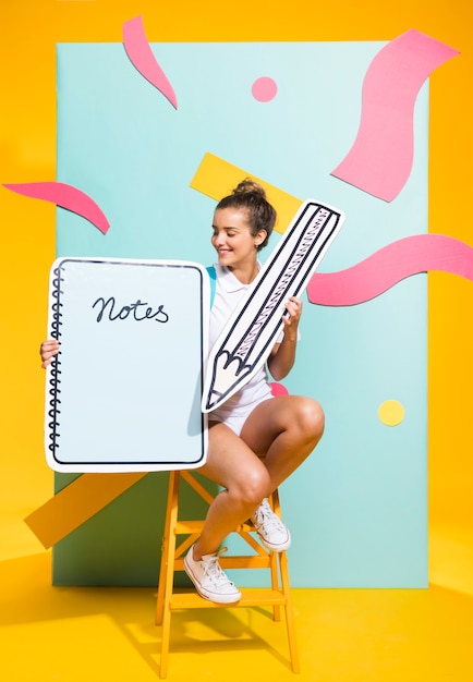 Portrait of schoolgirl with big notepad template