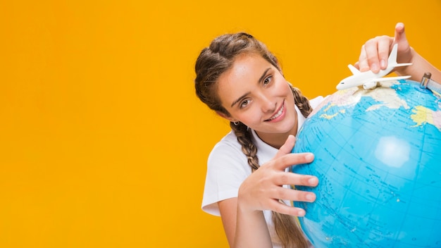 Portrait of schoolgirl with globe