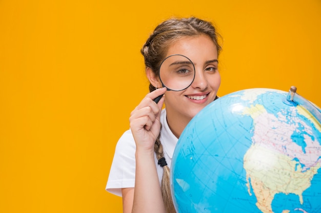 Portrait of schoolgirl with globe